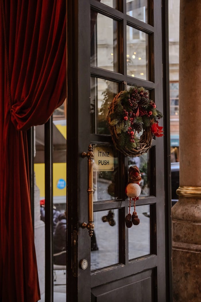 A cozy doorway adorned with a Christmas wreath in İstanbul, Türkiye, providing a warm holiday atmosphere.